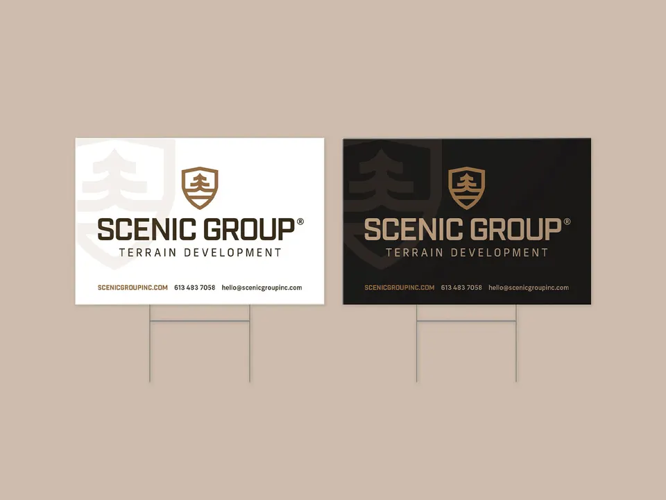 Two lawn signs, white and black, on a tan ground